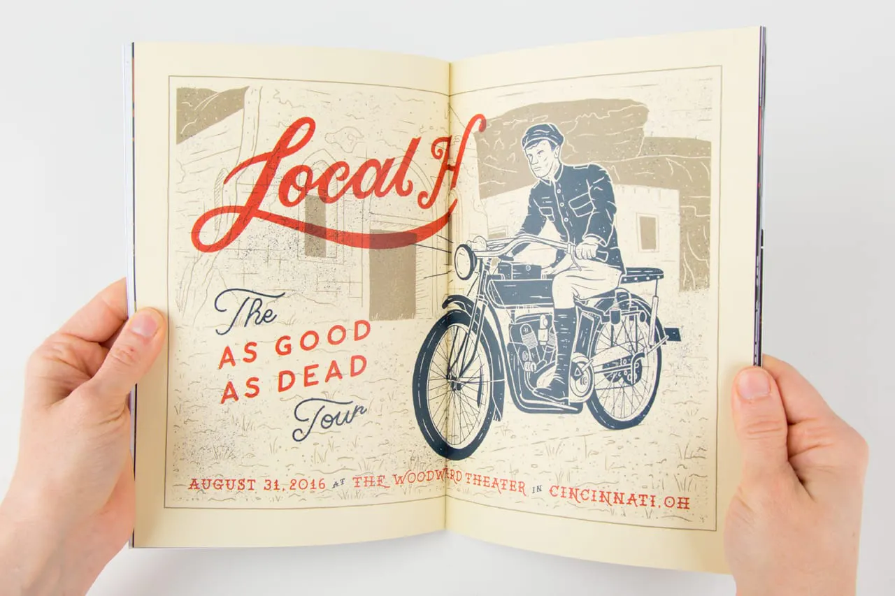 Two hands holding open a portfolio book to a motorcycle illustration.