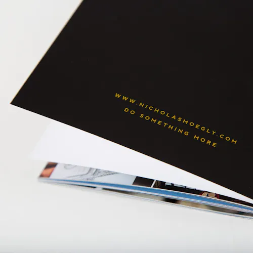 The back of a portfolio book printed with an email address and Do Something More.