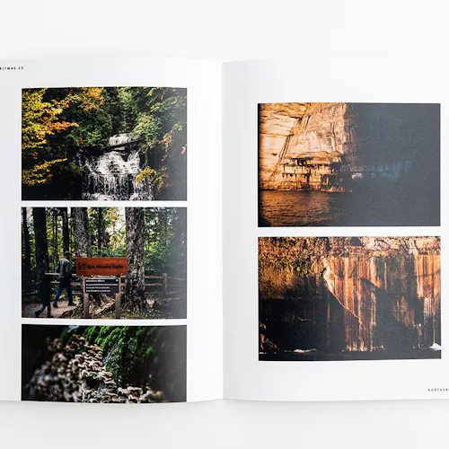A visual journal laying open to images of rock and forest landscapes.