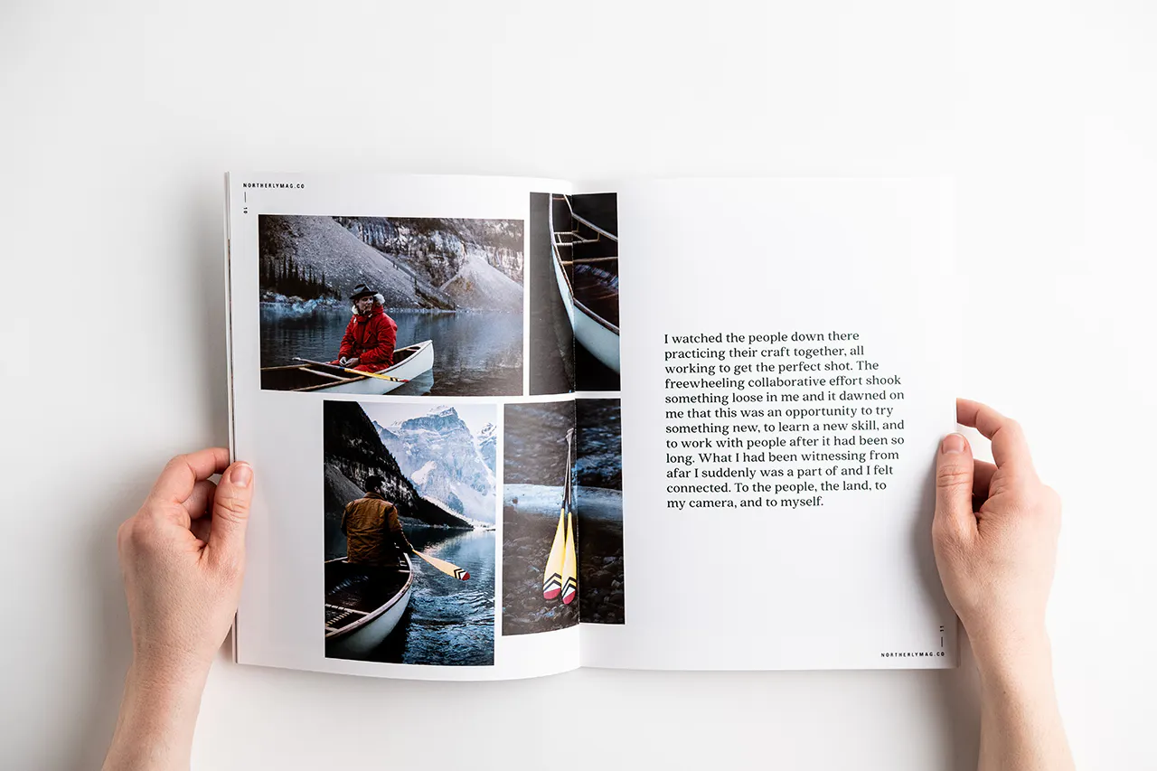 Two hands holding open a visual journal to images of winter canoeing.