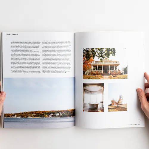 Two hands holding open a visual journal to images of a house, bathtub, autumn tree and shoreline.