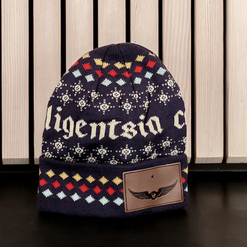 A Navy blue stocking cap printed with Intelligentsia in white and patterns of stars and diamonds.