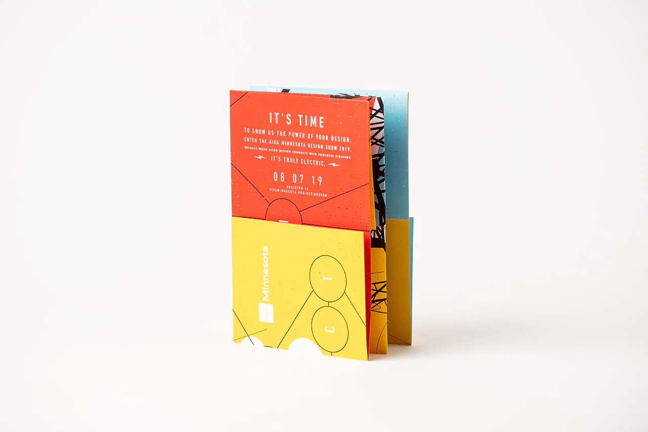 A folded direct mail with a yellow, red and blue design and printed with It's Time on the front.