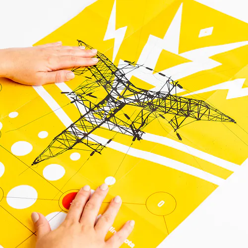 Two hands laying on an unfolded piece of direct mail with a yellow, black and white design.