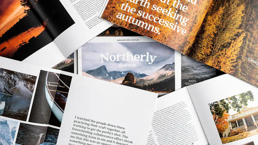 Various photography magazines laying open and on top of each other with perfect bindings and outdoor imagery.