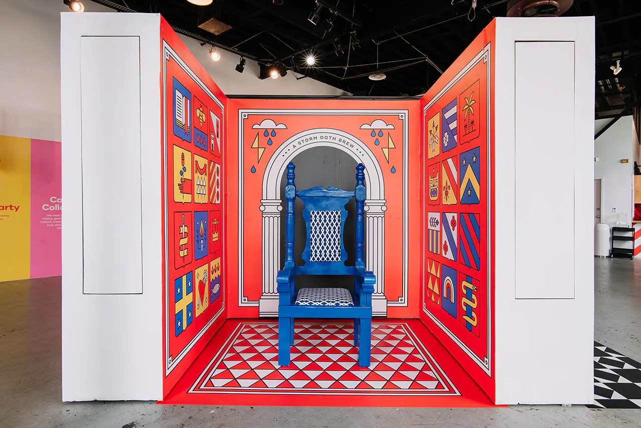 A blue chair sitting in the middle of a display with custom wall decals printed with flags surrounding it.