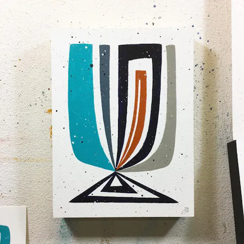 A custom art print with an abstract design in teal, gray, black and red.