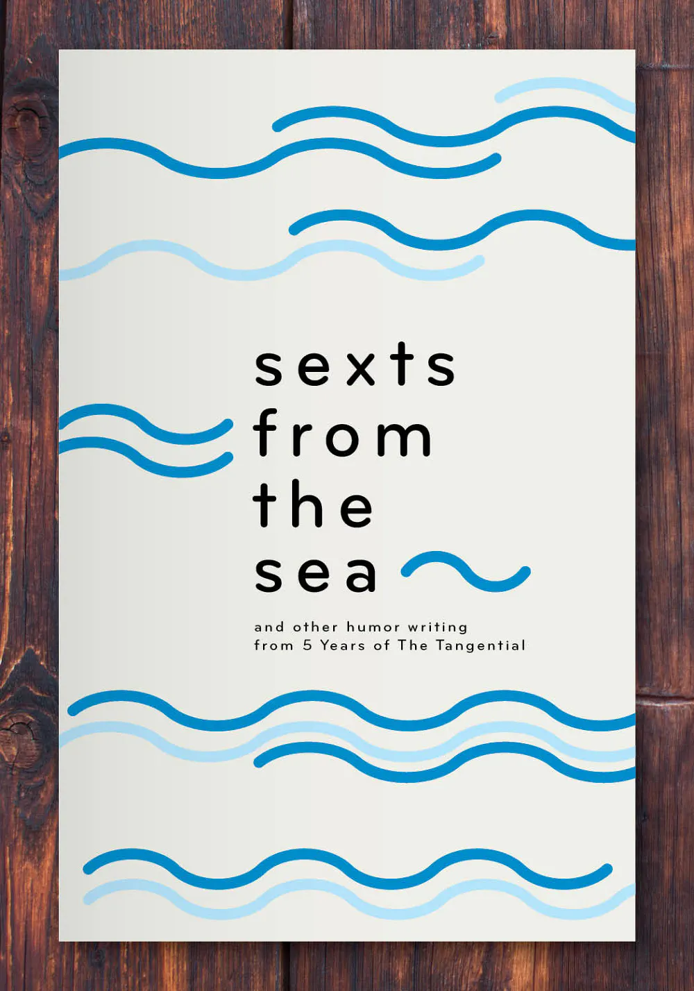 A custom book printed with a wavy blue design and Sexts from the Sea in black text.