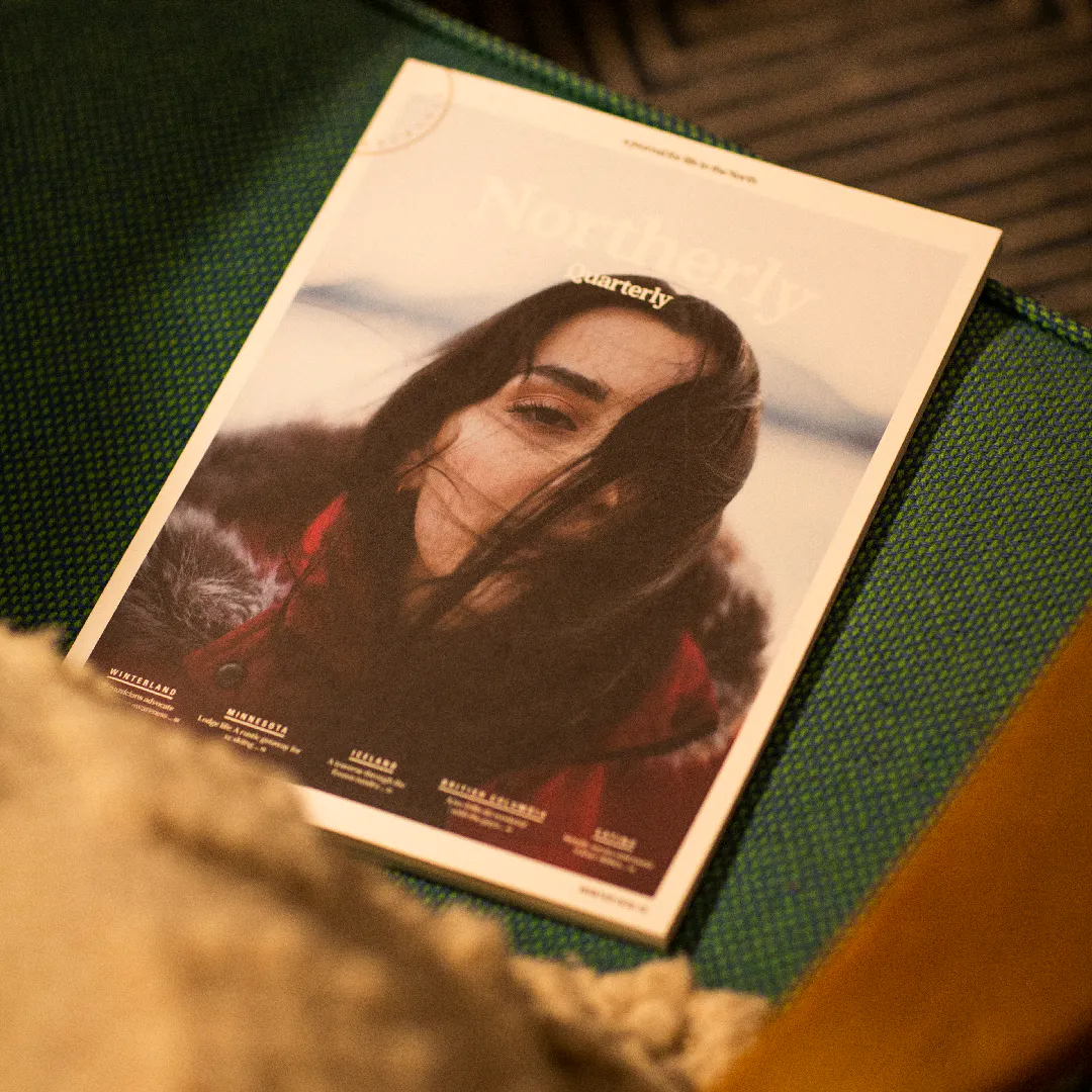 A Northerly photography magazine with a dark-haired woman on the cover placed on the seat of a chair.