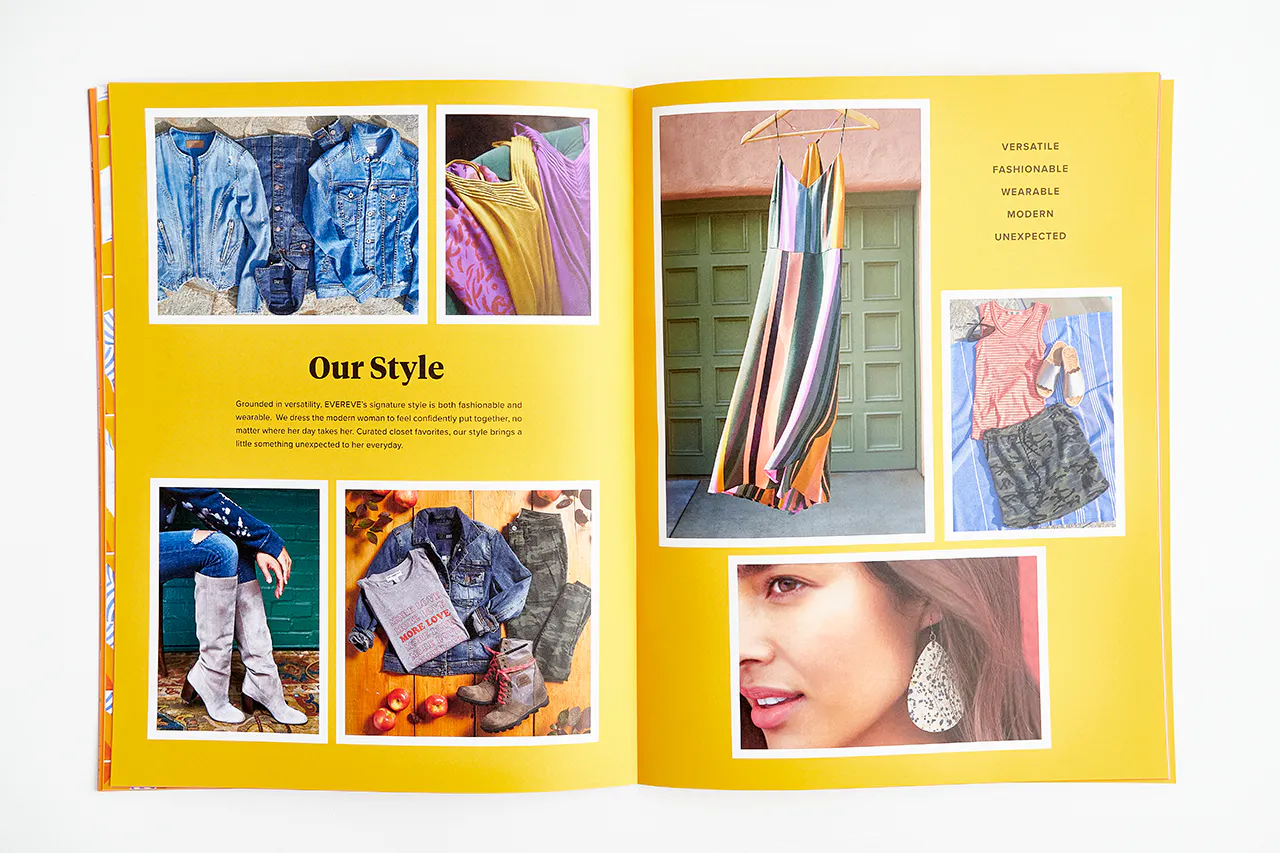 An Evereve brand book laying open to images of various clothing against a bright yellow background and Our Style in black.