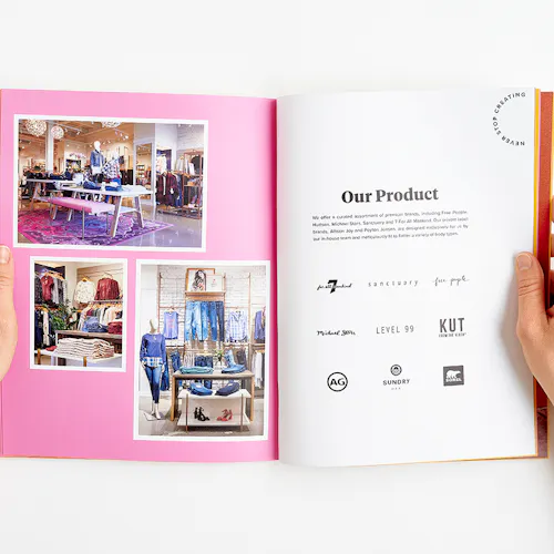 Two hands holding open an Evereve brand book to images of their retail store and Our Product in black.