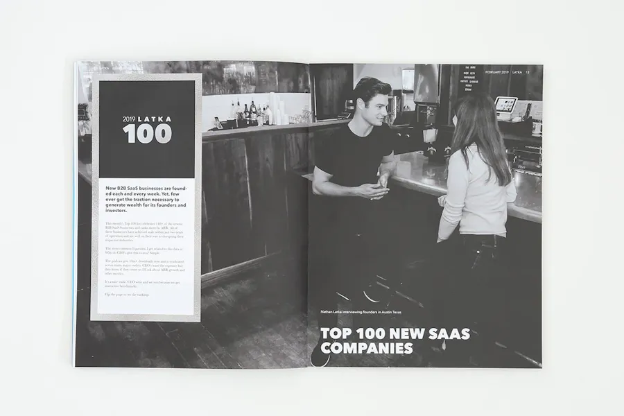 A direct mail magazine laying open to a black and white image of a man talking to a woman at a bar.