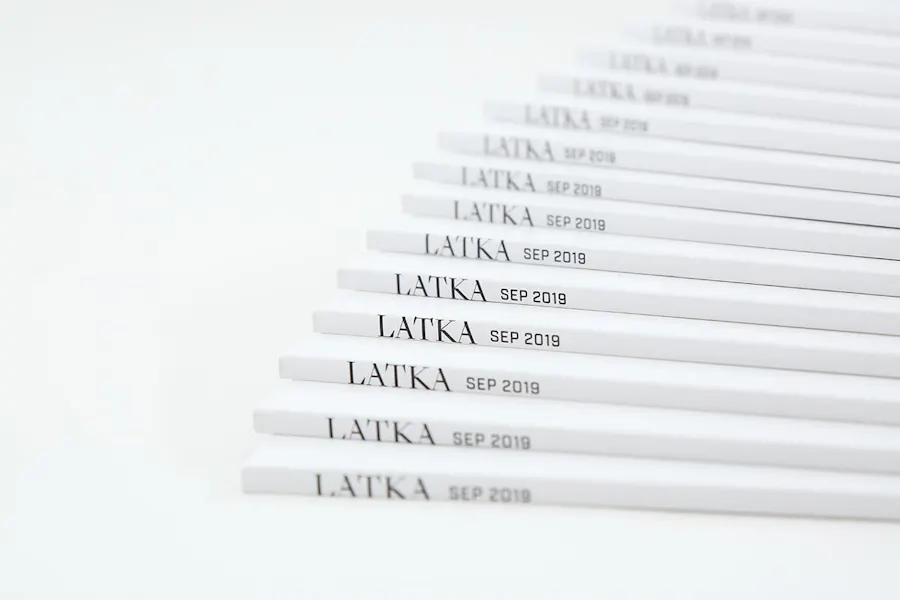 Direct mail magazines fanned out with a white cover and Latka Sept 2019 in black text on the spine.