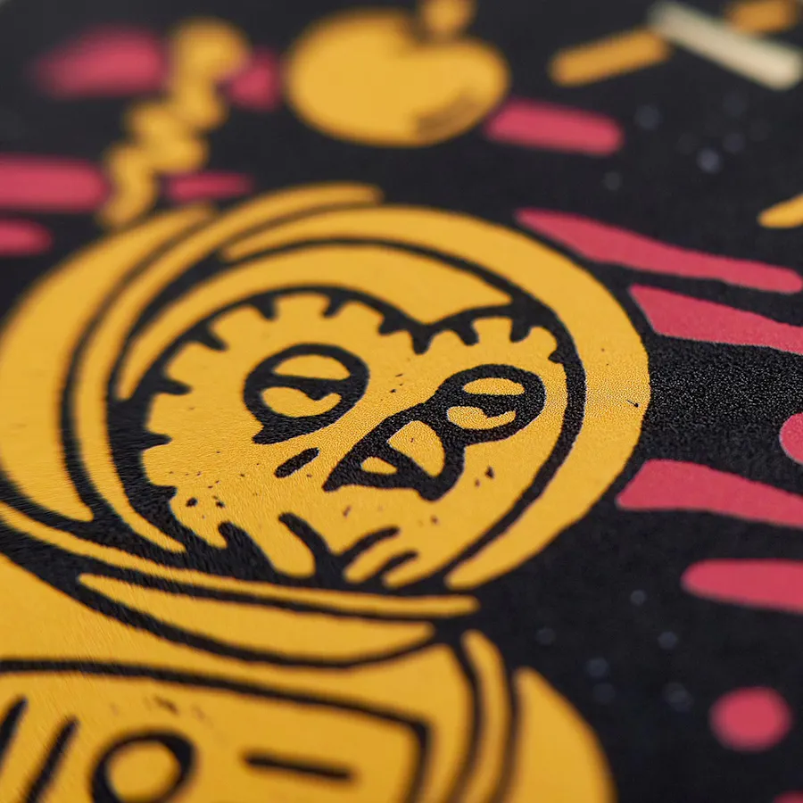 A postcard printed with an owl design in black, gold and red.