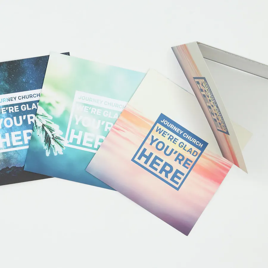 Four church brochures with outreach marketing and printed with We're Glad Your Here on the front.