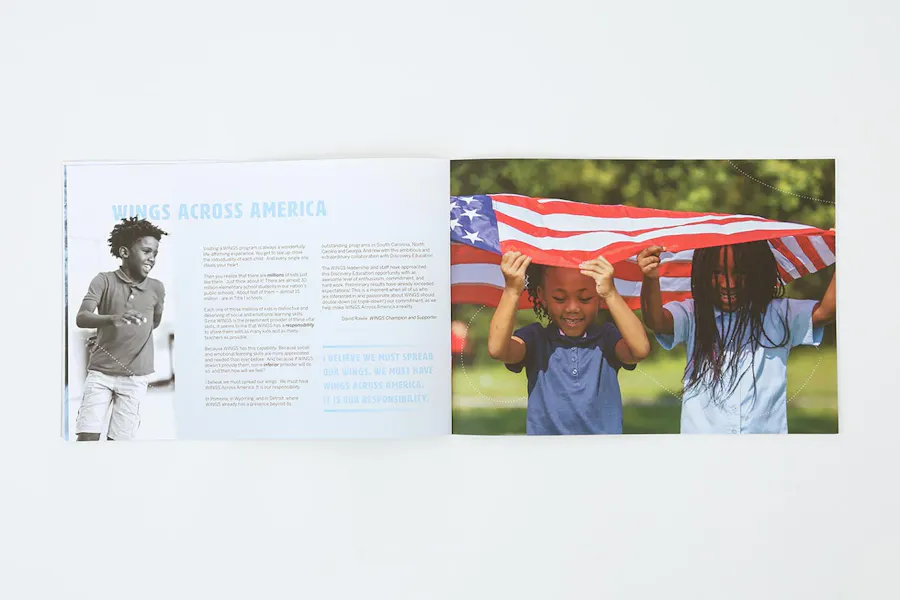 A nonprofit marketing booklet laying open to company information and an image of two kids under a flag.