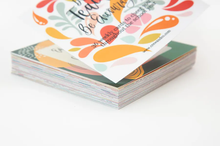 A deck of motivational cards with a bright floral design and encouraging sayings.