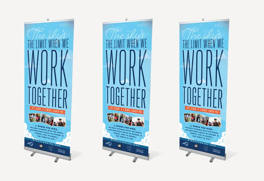 Three custom retractable banners printed with The sky's the limit when we work together and a blue background.