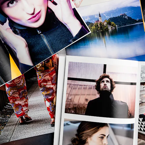 ©Brian Hammonds Photography A pile of photography booklets laying open and on each other with images of a man, a woman, printed pants and a castle.