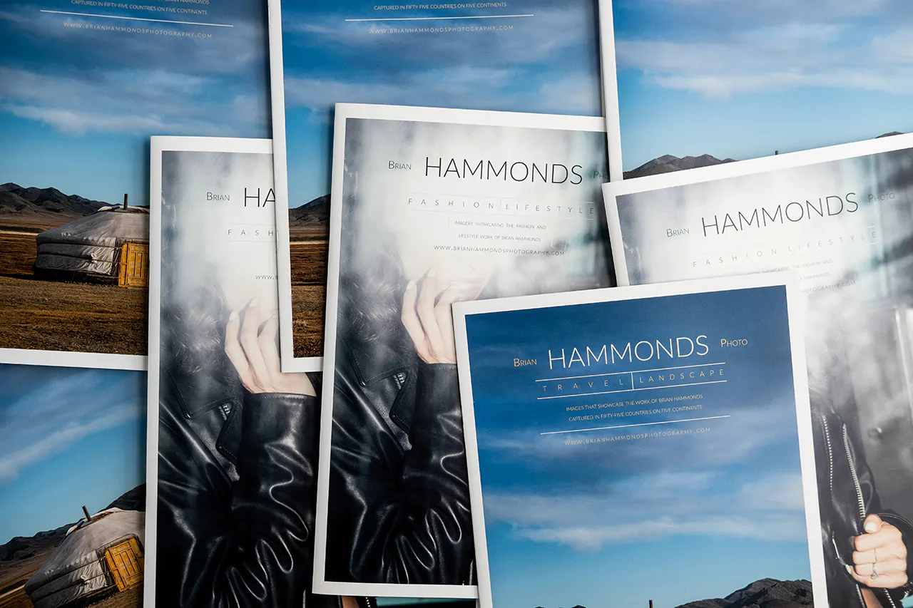 A pile of photography portfolios laying on top of each other with Brian Hammonds Photo on the cover.