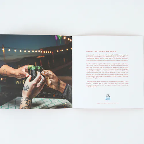 ©Will Strawser A portfolio printed with an image of three hands toasting with shot glasses and details printed in red.