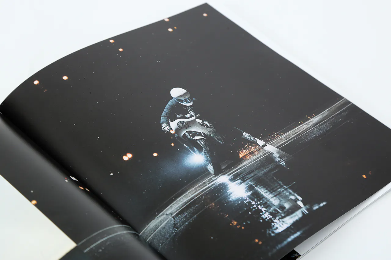 A photography booklet printed with an image of a person on a motorcycle riding at night.