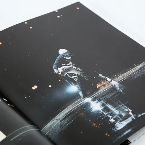 A photography booklet printed with an image of a person on a motorcycle riding at night.