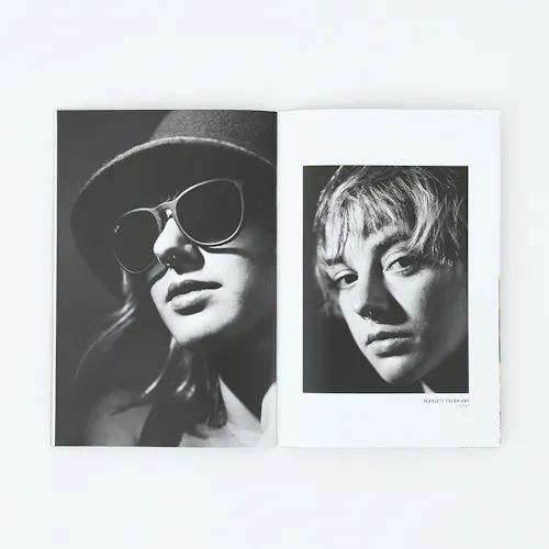 ©Steve West Photo A portfolio laying open to black and white images of a woman wearing a hat and sunglasses and one with a nose ring.