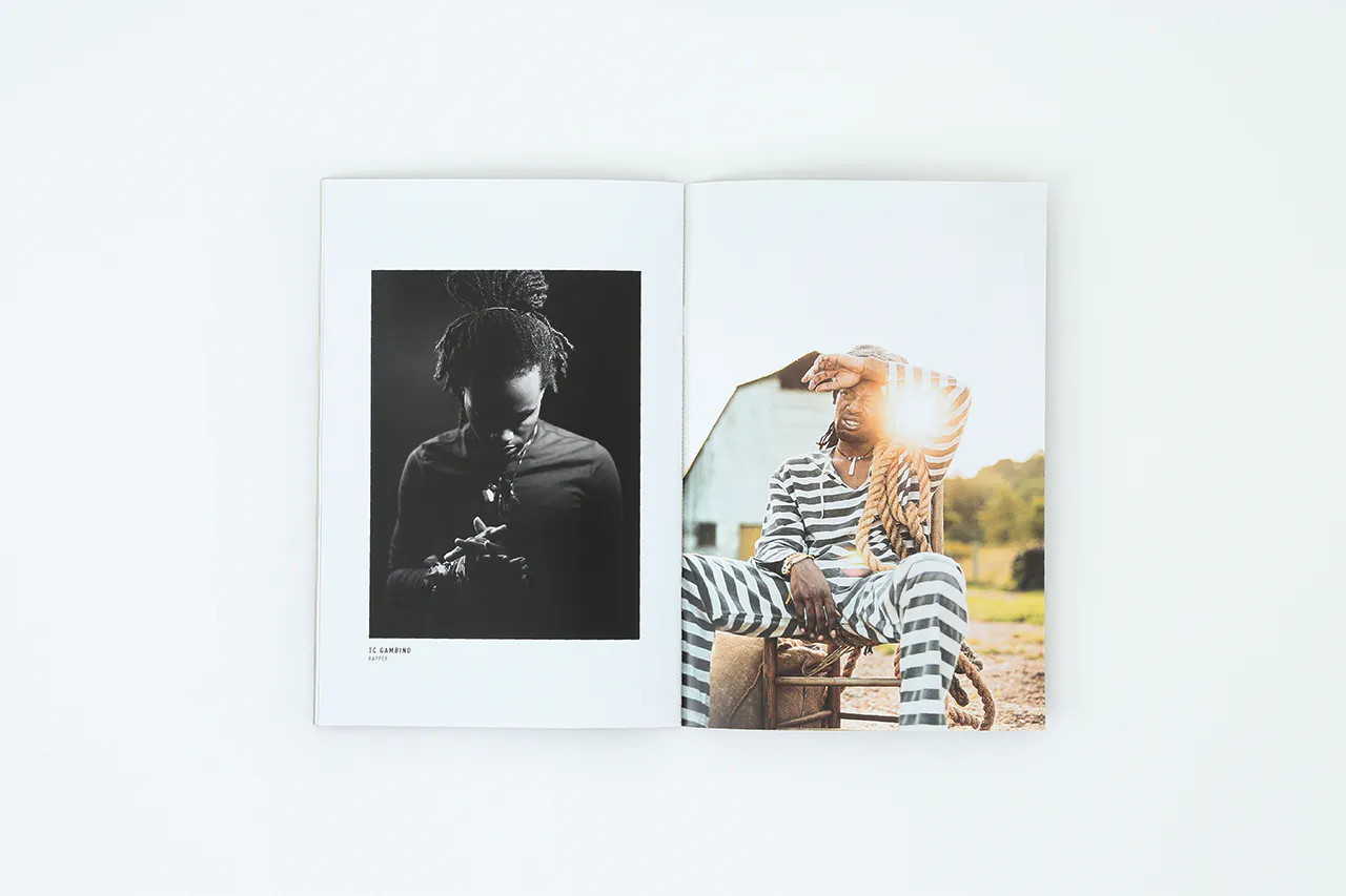 A portfolio printed with images of a man looking down clasping his hands and a man in a striped suit sitting in a chair.