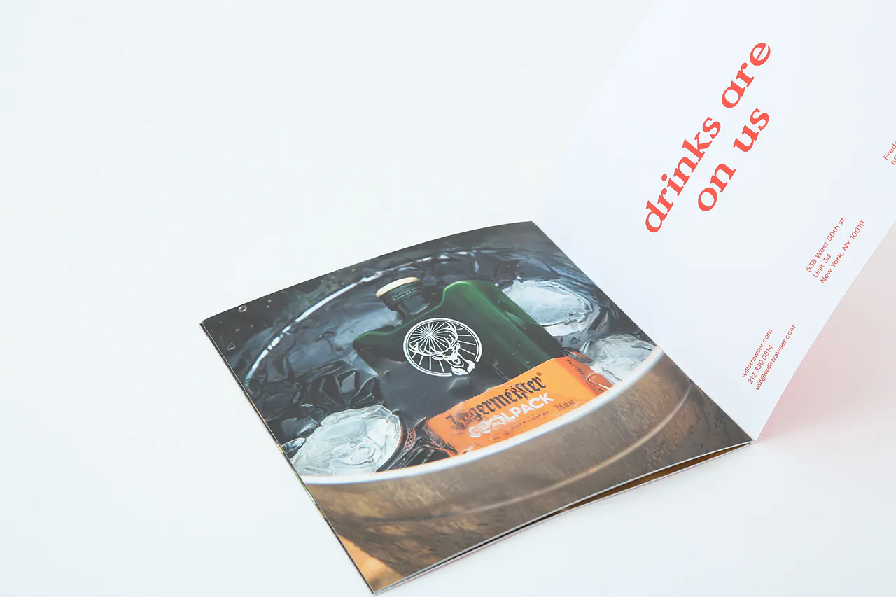 A photography book printed with an image of a bottle of alcohol in a bucket of ice.