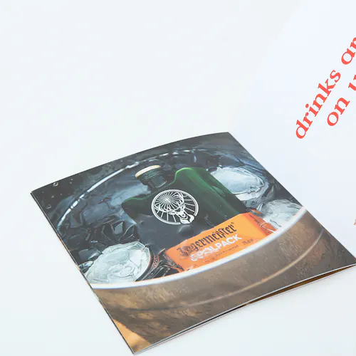 A photography book printed with an image of a bottle of alcohol in a bucket of ice.