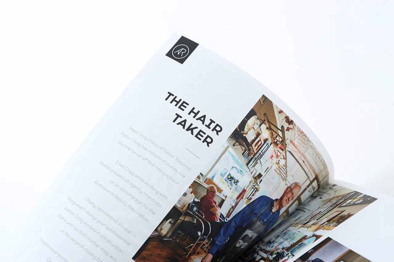 A photography portfolio flipping open to an image of a barbershop and printed with The Hair Taker.