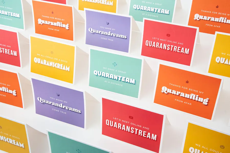 Custom greeting cards lined up in rows with bright colors and quarantine puns and sayings on the front.
