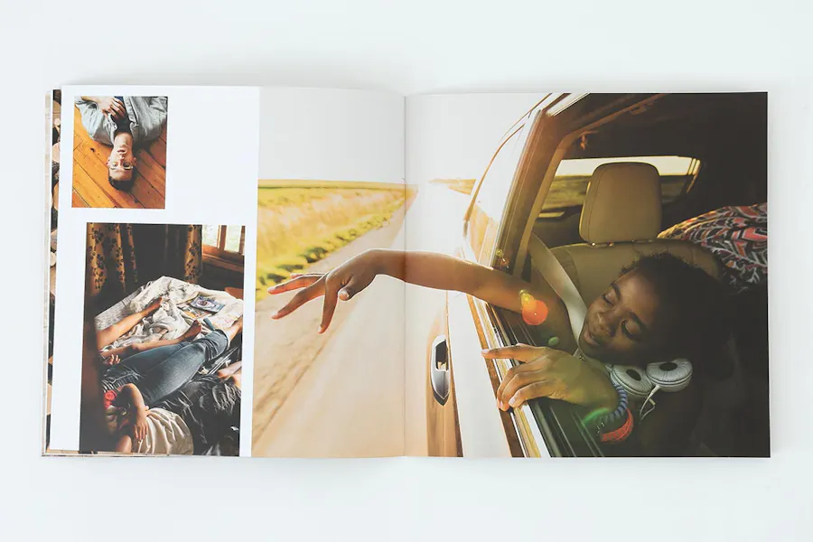 A photography portfolio laying open to images of a girl in a car, people laying on a bed and a man laying on the floor.