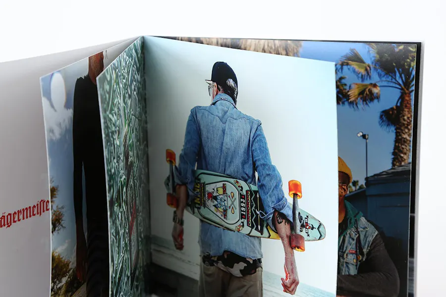 A photography booklet standing open with skateboarding images inside.