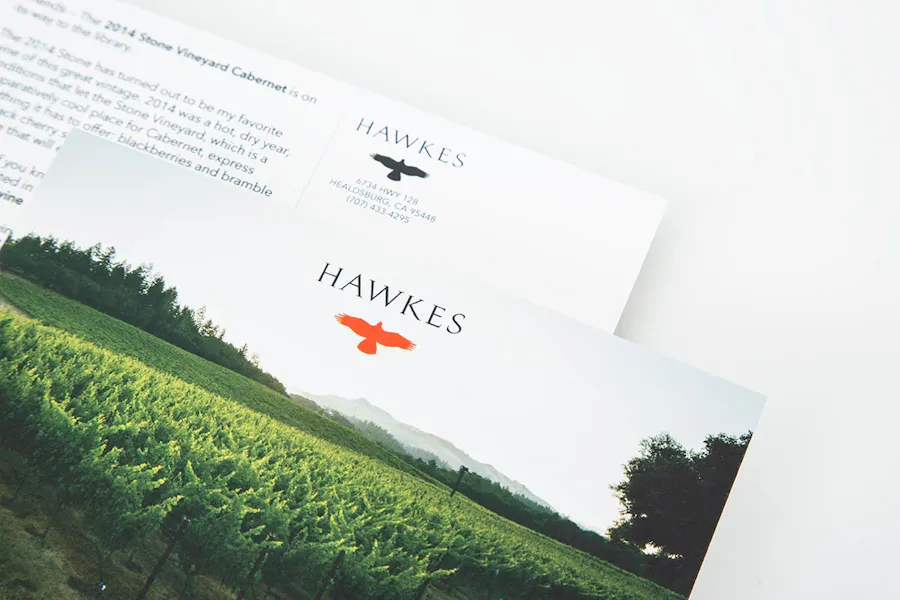 Two winery mailers with an image of a vineyard on the front and winery details on the back.