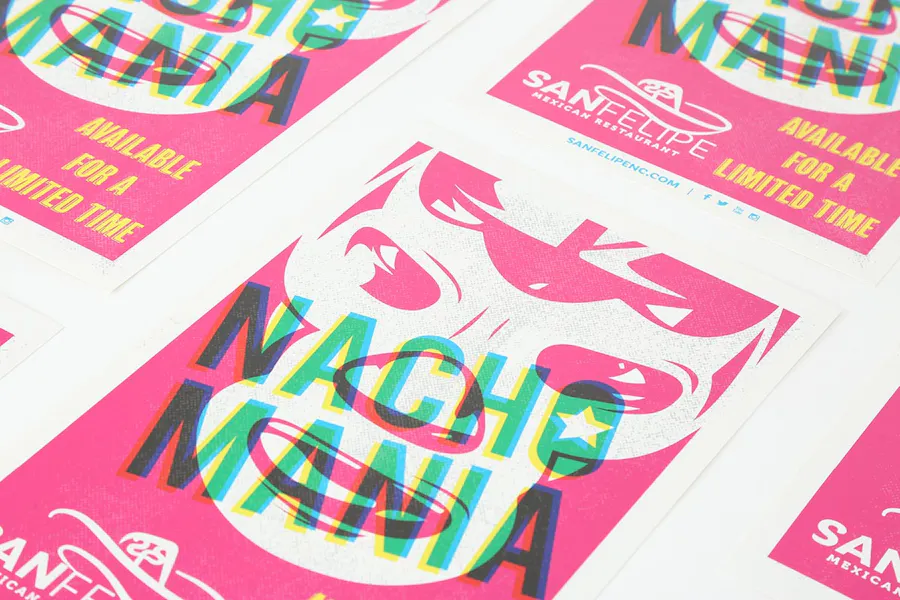 Four custom menus printed with a pink, white and green design and Nacho Mania on the front.