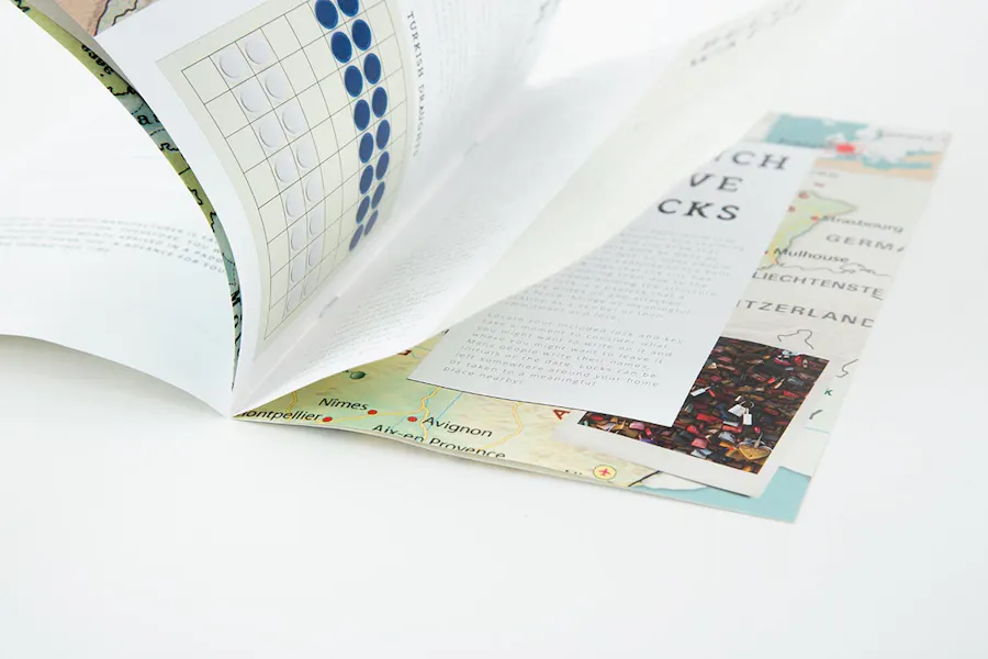 A travel guide book laying open with pages flipping by.