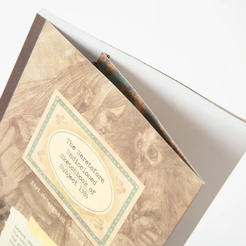 A custom sketchbook printed with The Heretofore Undisclosed Sketchbook of Subject 1984 on the cover.