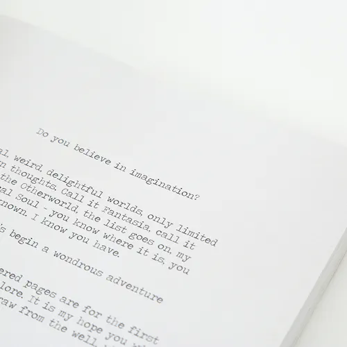 A sketchbook laying open to text that reads Do you believe in imagination?