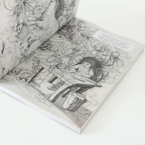 A sketchbook laying open to illustrations of a young girl sitting at a desk and drawing.