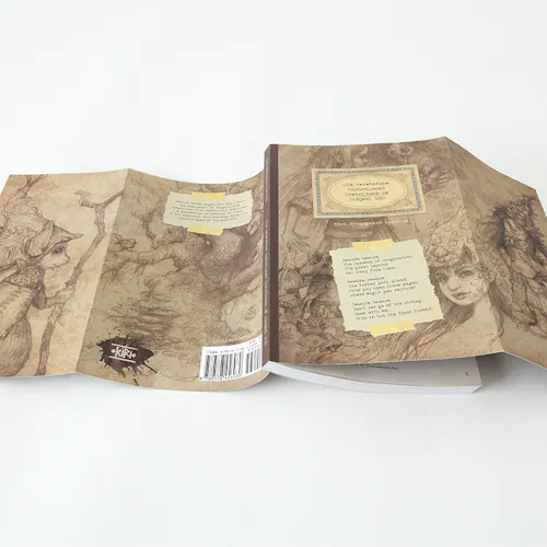 A sketchbook laying open with its spine up and a sepia-colored cover unfolded.