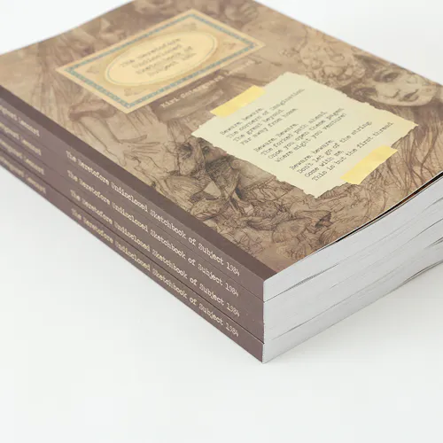 A stack of custom sketchbooks printed with a sepia-colored cover and a perfect binding.