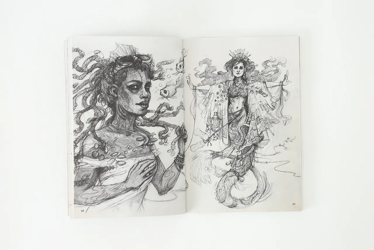 A sketchbook laying open to black and white illustrations of two fantasy characters.