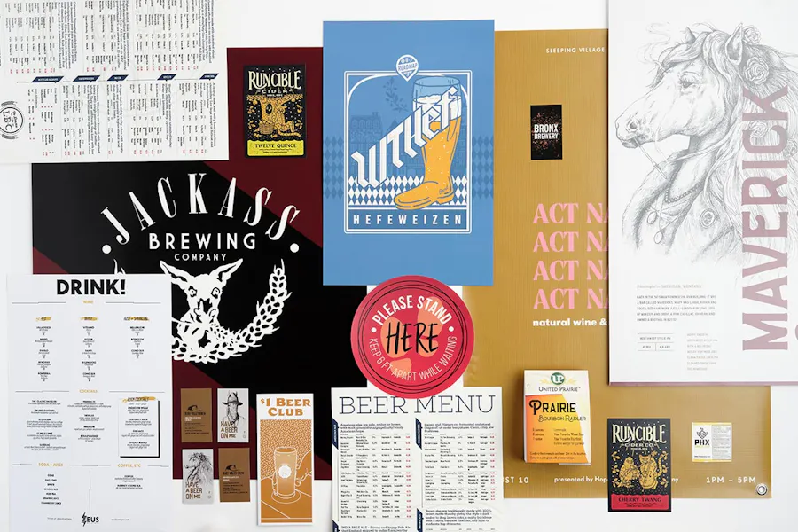 An array of brewery marketing materials, including menus, posters, signs, brochures, decals, postcards and table tents.