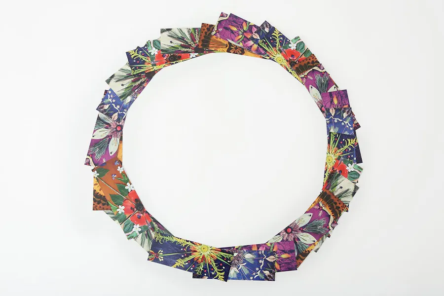 Custom bookmarks fanned out in a circle and printed with images of nature mandalas.