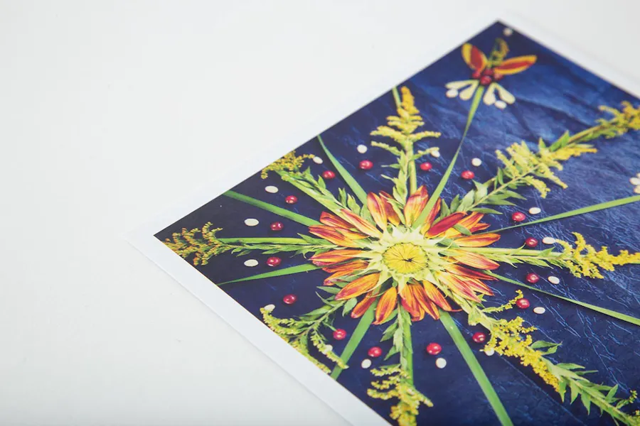 A print of a flower mandala with a blue, green, orange, yellow and red design.
