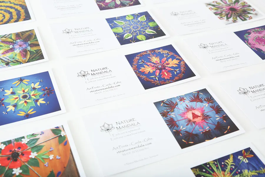 Custom postcards lined up in rows with Nature Mandala in black text and a mandala design in various colors.