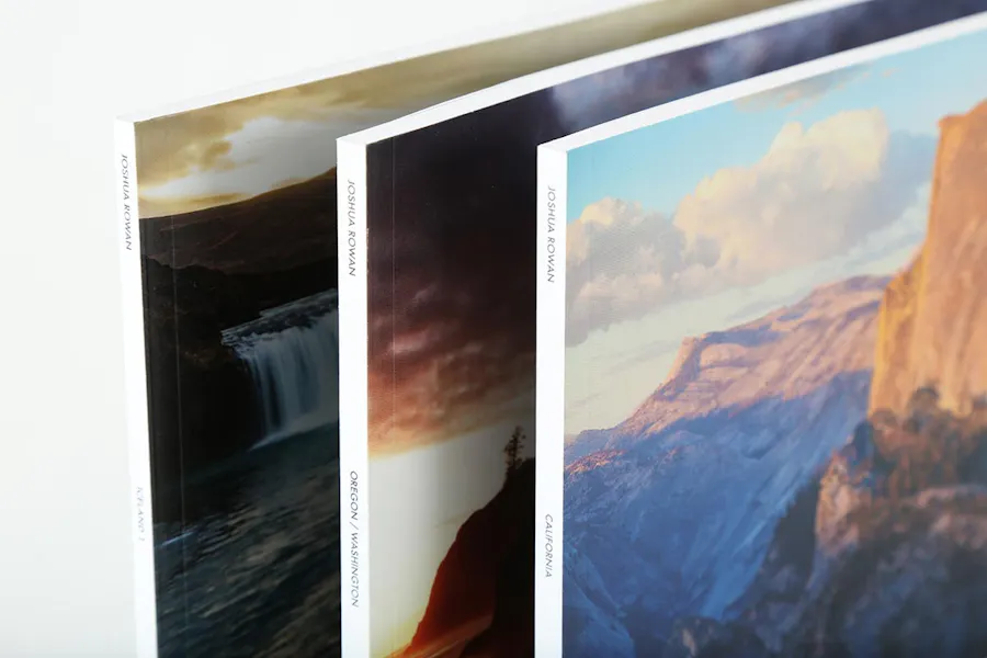 Three marketing booklets with a perfect binding and landscape photography on the cover.