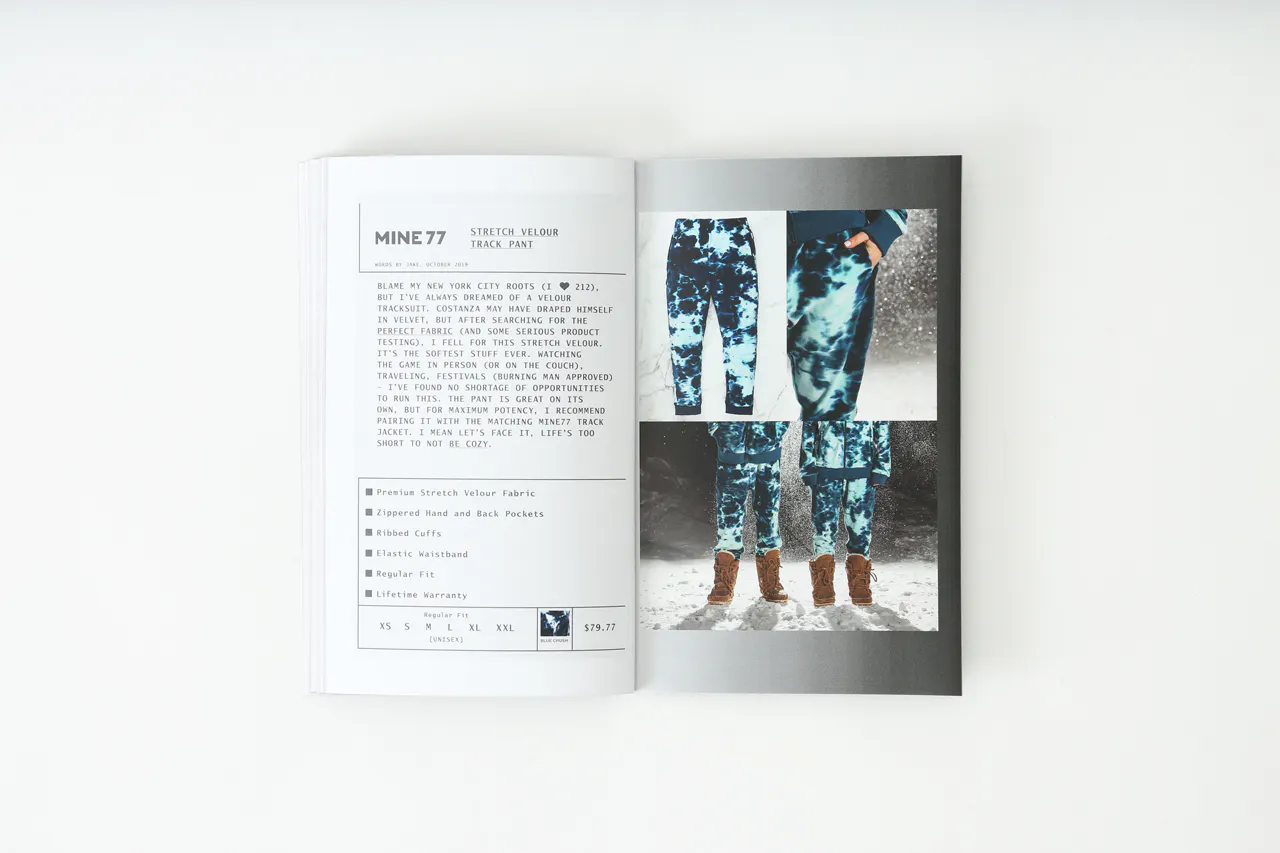 A Mine77 lookbook laying open to images of two people wearing printed track pants and details about them.